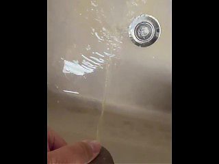 Soft Asian penis peeing in sink