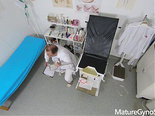 Sexy mature woman caught naked in the office of Freaky Doctor